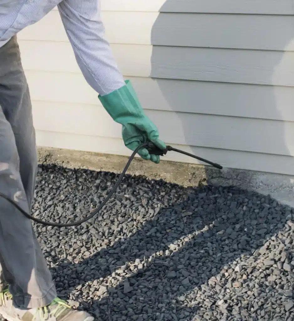 Pest control barriers being applied by a Spokane Greenscapes technician