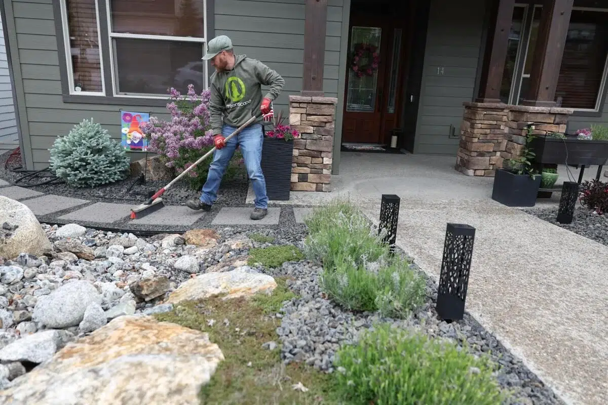 Spring yard cleanup by Greenscape Landscaping, featuring meticulous maintenance of rock beds and plantings.