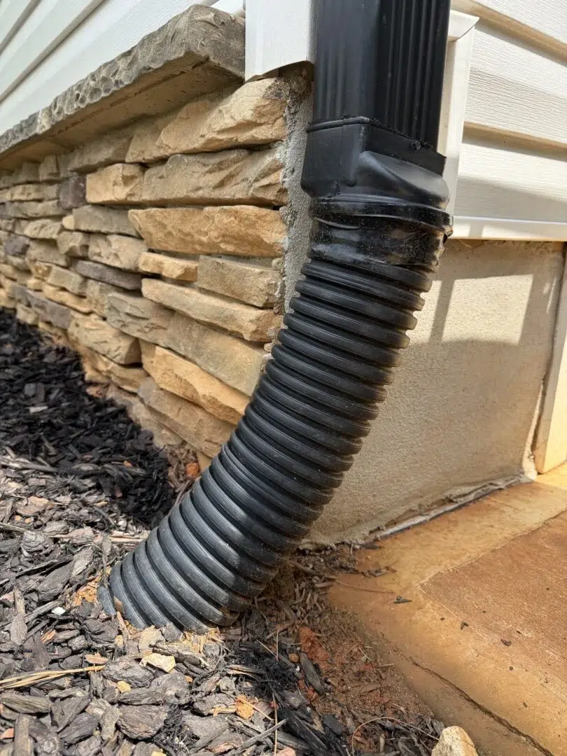 Downspout pipe draining into an underground pipe system