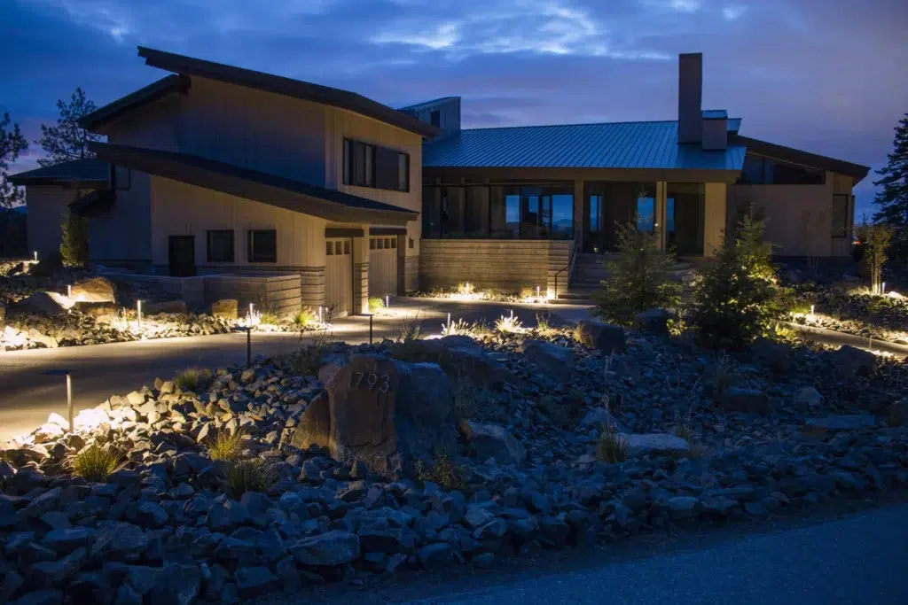 Front Yard Landscape Lighting Over Decorative Rock and Shrubs
