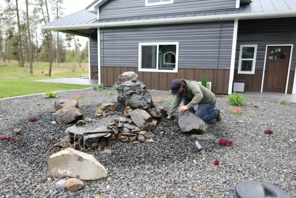 technician installs a backyard water feature